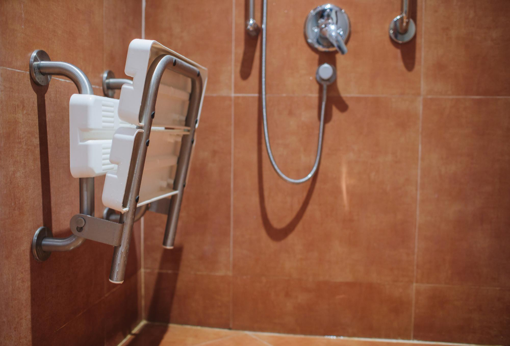 Shower with seat and grab bars for disabled and elderly people in the bathroom